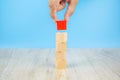 Close-up hand choose a cube shape wooden block toy stacked without graphics for Business design concept Royalty Free Stock Photo