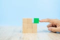 Close-up hand choose a cube shape wooden block toy stacked without graphics Royalty Free Stock Photo