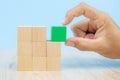 Close-up hand choose a cube shape wooden block toy stacked without graphics Royalty Free Stock Photo