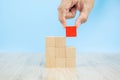 Close-up hand choose a cube shape wooden block toy stacked without graphics Royalty Free Stock Photo