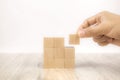 Close-up hand choose a cube shape wooden block toy stacked without graphics Royalty Free Stock Photo