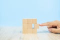 Close-up hand choose a cube shape wooden block toy stacked without graphics Royalty Free Stock Photo