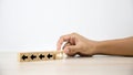 Close-up hand choose cube wooden toy block stacked with arrow icon pointing to opposite directions