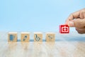 Close-up hand choose Health care and medical symbol icons on wooden toy blocks.