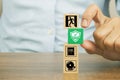 Close-up hand choose prevent symbol on cube wooden toy blocks stacked with fire exit icon