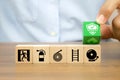 Close-up hand choose prevent symbol on cube wooden toy blocks stacked with fire exit icon Royalty Free Stock Photo