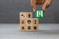 Close-up hand choose a wooden toy blocks with fire exit icon for fire safety protection Royalty Free Stock Photo