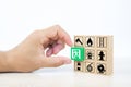 Close-up hand choose wooden toy blocks stacked with door exit sing icon Royalty Free Stock Photo