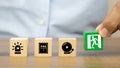 Close-up hand choose a wooden toy blocks stacked with fire exit icon Royalty Free Stock Photo