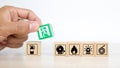 Close-up hand choose a wooden toy blocks stacked with fire exit icon Royalty Free Stock Photo