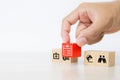 Close-up hand chooses cube wooden toy blocks stacked with insurance