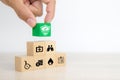 Close-up hand chooses cube wooden toy blocks stacked with prevent protect icon for safety