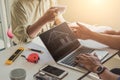 Close up hand of civil engineer or architect business working on blueprint architectural project at construction site at desk in