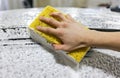 Close-up of hand cleaning black car of serviceman. The process of washing cars with foam and sponge. Royalty Free Stock Photo