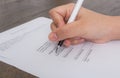 Close up of hand completing an employment application form