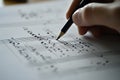 Closeup Hand Composing Music Graphite Pencil on Sheet Music Royalty Free Stock Photo