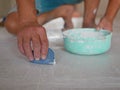 Ã Â¹â¡Hand of a construction worker grunting ceramic tiles on the house floor - tiling work