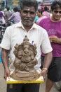 Close up of hand crafted Ganesha idol statues displayed in the market during Ganesh Festival.