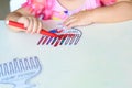 Close up hand cute little toddler kid painting with color pen paper menorah and candle.