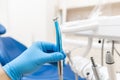 Close-up hand of dentist in the glove holds dental high speed turbine. Office where dentist conducts inspection and Royalty Free Stock Photo