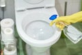 Close up of hand with detergent cleaning toilet Royalty Free Stock Photo