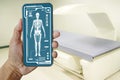 Hand Doctor showing Image of DXA bone density scan on a smartphone in analytics at Hologram human anatomy and skeleton to