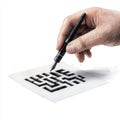 A closeup of a hand drawing a maze on paper with an ink pen showcasing creativity and artistic skill in a simple setting Royalty Free Stock Photo
