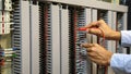 Close-up hand of electrical engineer using measuring equipment to checking electric current voltage at circuit breaker Royalty Free Stock Photo