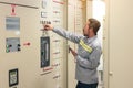 Close up hand of engineer or electrician man working check the electrical system with tablet at factory Royalty Free Stock Photo