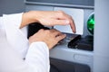 Close-up Of Hand Entering Pin At An ATM Royalty Free Stock Photo