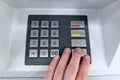 Close-up of hand entering pin code at ATM machine Royalty Free Stock Photo