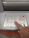 Close-up of hand entering PIN pass code on ATM bank machine keypad Royalty Free Stock Photo