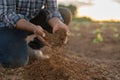 Close up hand of a farmer checking soil health before growth a seed of vegetable or plant seedling. Business or ecology concept