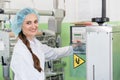 Woman manufacturing engineer adjusting the settings of an industrial machine Royalty Free Stock Photo
