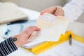 Close-up of the hand of a female patient receiving a prescription