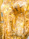Close up hand filled with gold leaf of statue Buddha. concept shows the devotion of the Buddhists Royalty Free Stock Photo