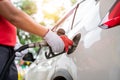 Close-up hand of gas refueling worker wearing gloves is refueling customers, Pumping equipment gas at gas station Royalty Free Stock Photo