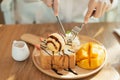 Close up of hand girl eating honey toast on wood table in the cafe Royalty Free Stock Photo