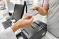 Close up of hand giving bank card to pharmacist