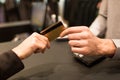 Close up of hand giving credit card to seller Royalty Free Stock Photo