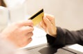 Close up of hand giving credit card to seller Royalty Free Stock Photo