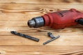 Close up hand with glove is preparing electric drill on wooden table Royalty Free Stock Photo
