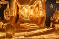 Close up of hand of the Golden Buddha statue, Two golden Buddha statue Sitting on the left and right side of the large golden Royalty Free Stock Photo