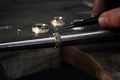 Close-up of hand of a goldsmith setting the diamond on the ring. Craft jewelery making with professional tools. Royalty Free Stock Photo