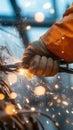 Close up of hand gripping heavy duty wire, creating sparks and light