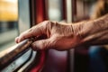 close-up of a hand gripping a rail inside a bus