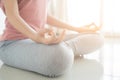 Close up hand and half body of healthy woman sit in lotus Yoga position.Young healthy woman sitting posture exercise in home.