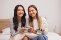 Close up hand.Happy LGBT lesbian couple holding joysticks and playing video game in relax day