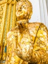 Close up hand and head filled with gold leaf of statue Buddha. concept shows the devotion of the Buddhists