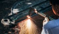 Close up hand heavy industrial worker is working on metal work factory process by Cutting sheet Royalty Free Stock Photo